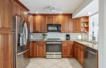 Kitchen Features Stainless Appliances and Fridge with Ice Maker